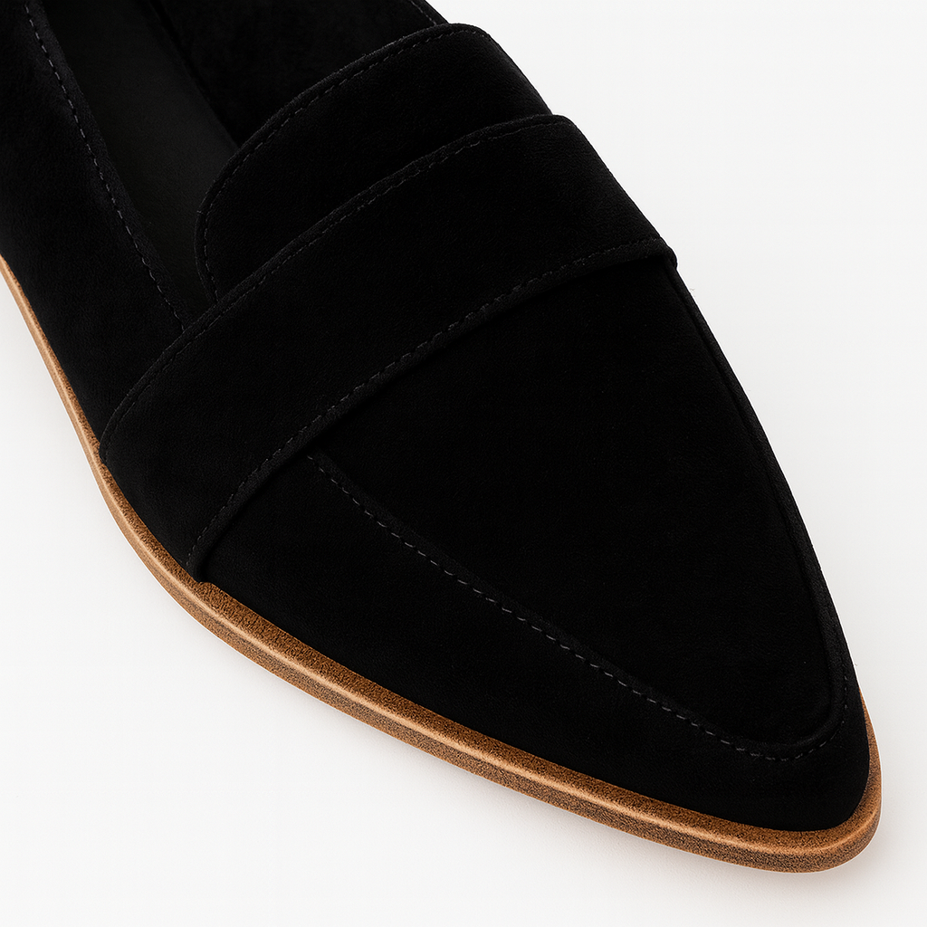 Suede loafer with a pointed toe, low heel, and strap detail across the upper.