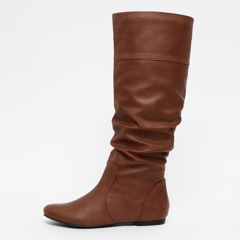 Faux leather slouch knee-high boots with pointed toe and flat sole, styled for casual everyday wear.