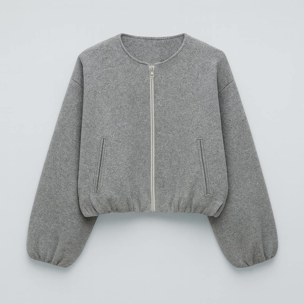 A zip-up jacket featuring a minimalist round neckline, dropped shoulders, and oversized balloon sleeves. The design includes front slit pockets and a gathered hem, creating a relaxed, casual silhouette perfect for layering in cool weather.