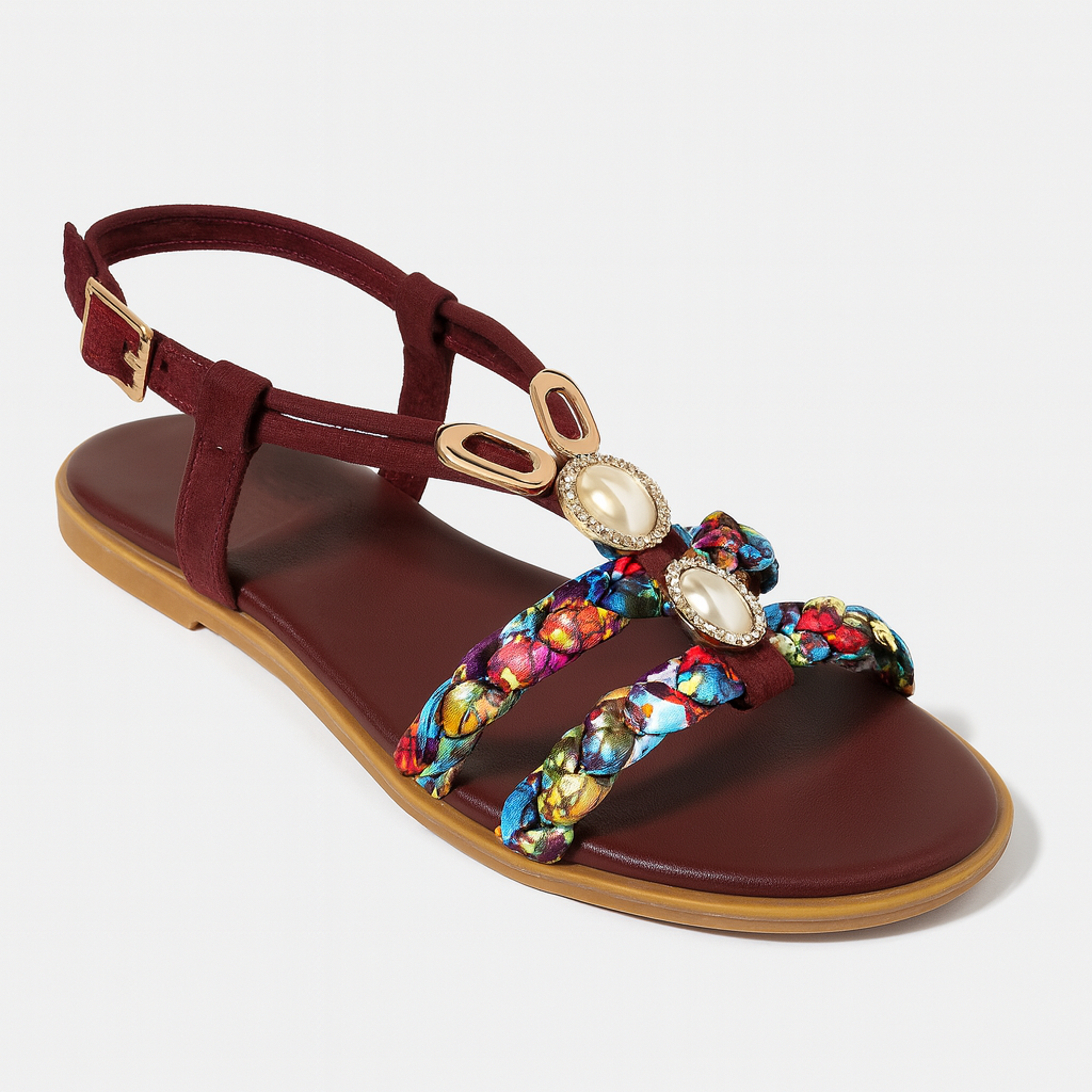 Flat sandal with ankle strap, braided multicolor straps, and decorative pearl-like embellishments set in gold accents.
