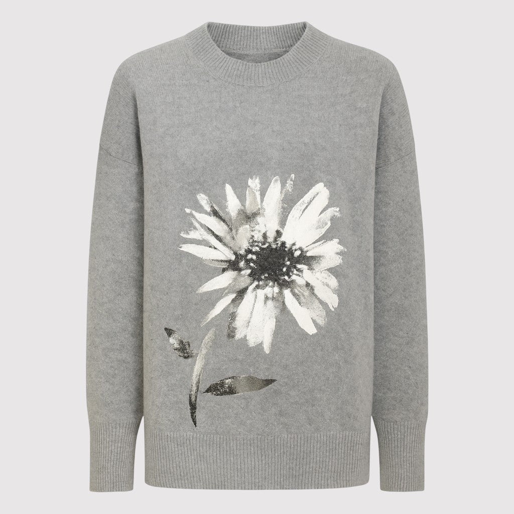 A patterned turtleneck sweater featuring intricate paisley and floral designs, with ribbed cuffs, hem, and a tall ribbed turtleneck.