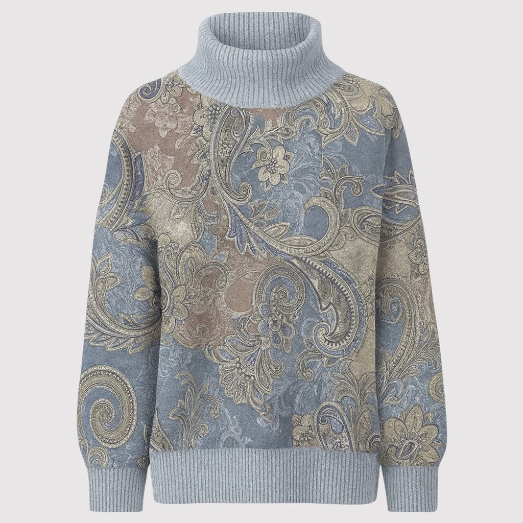 A patterned turtleneck sweater featuring intricate paisley and floral designs, with ribbed cuffs, hem, and a tall ribbed turtleneck.