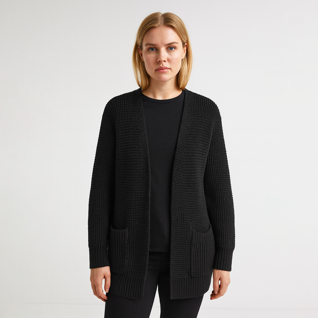 A long open-front knit cardigan with a textured waffle pattern, ribbed cuffs and hem, and two front patch pockets.