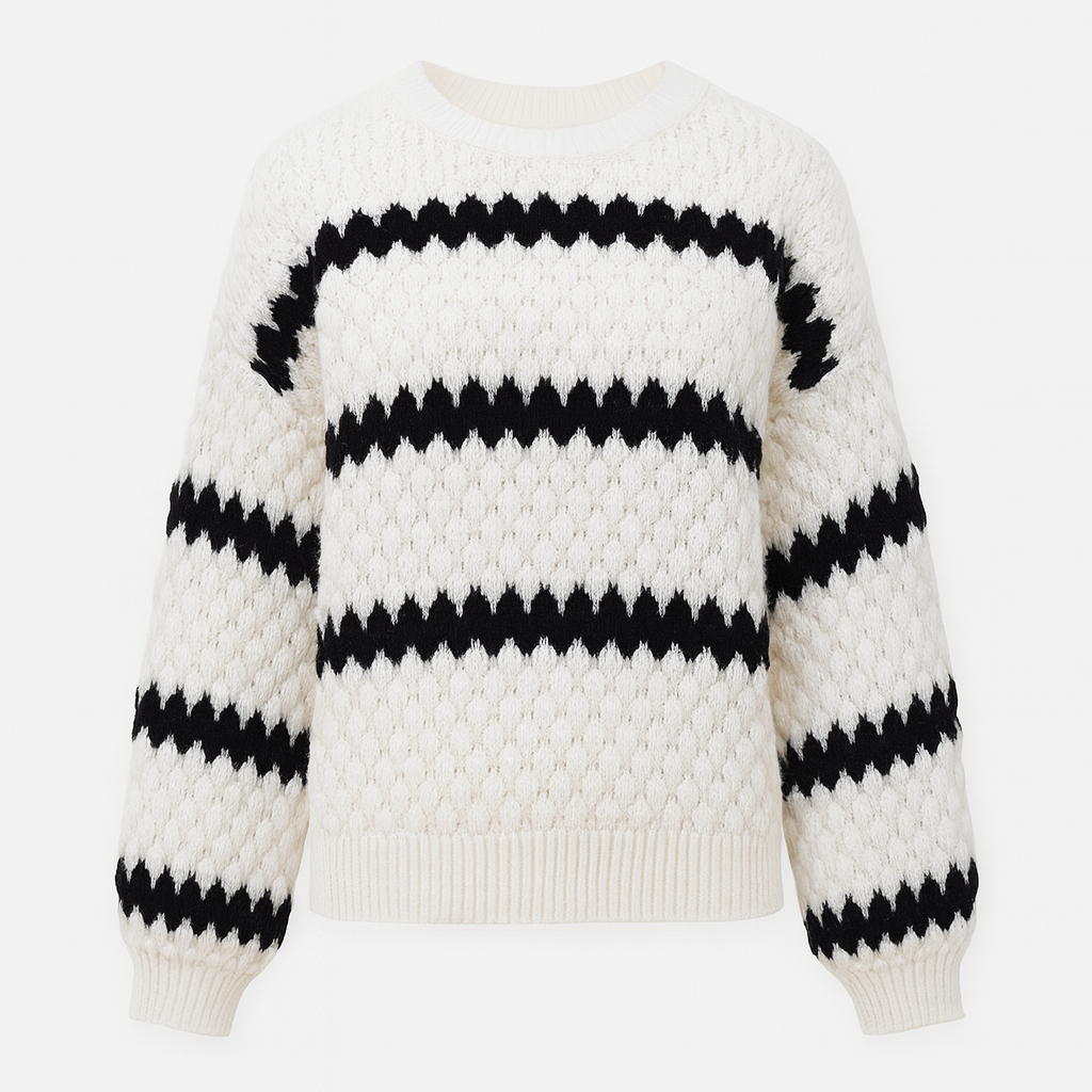 A white knit sweater with bold black zig-zag stripes, long balloon sleeves, and a ribbed crew neckline