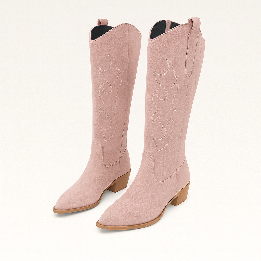 A pair of suede cowboy boots featuring decorative stitching on the shaft, pull tabs on the sides, and low stacked wooden heels. The boots have pointed toes and a classic Western-inspired silhouette.