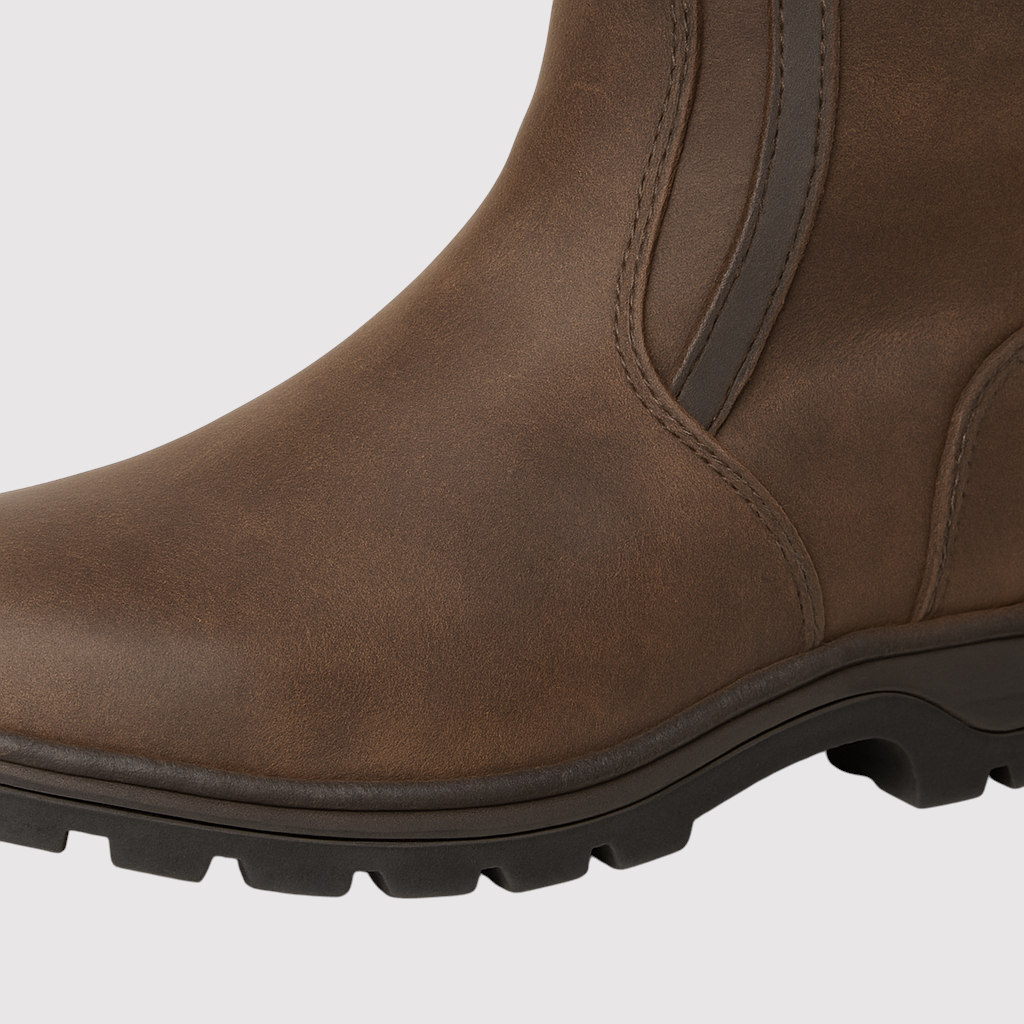 Knee-high riding boots with buckle detailing, contoured shaft, and traction sole designed for outdoor and equestrian wear