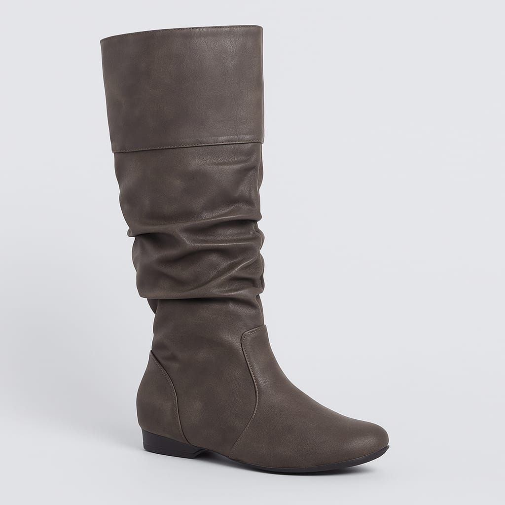 A sleek mid-calf boot with a slouchy leather design and rounded toe. The flat sole provides comfort and ease for everyday wear, while the soft, gathered texture adds a touch of casual sophistication to the minimalist silhouette.