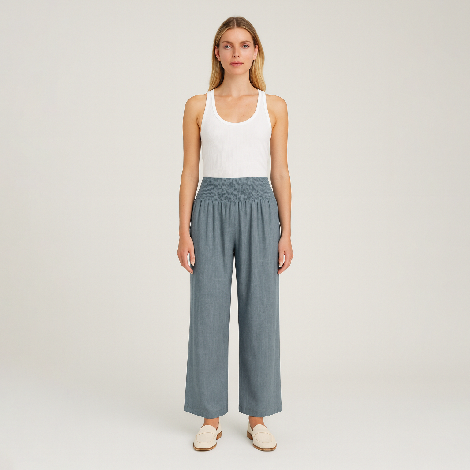 Wide-leg pants with smocked waistband and pleated detailing.