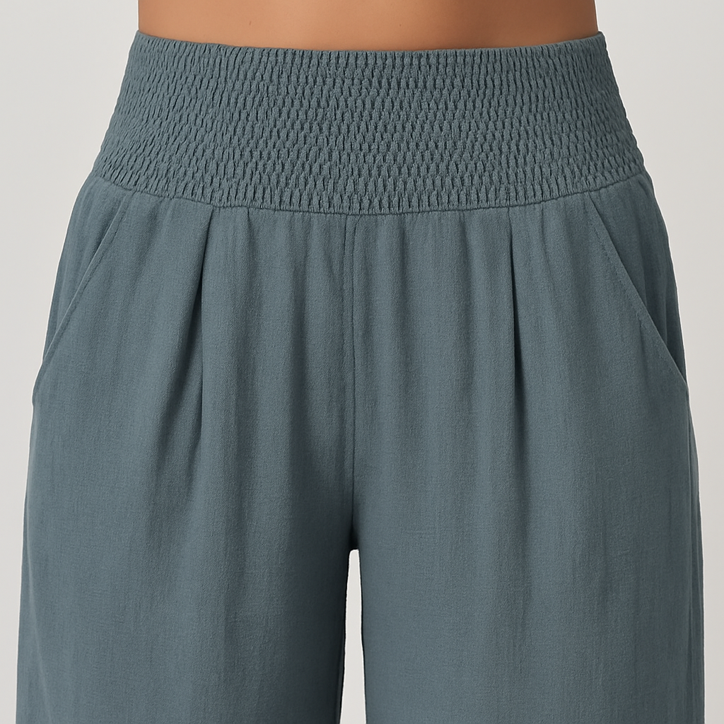 Wide-leg pants with smocked waistband and pleated detailing.