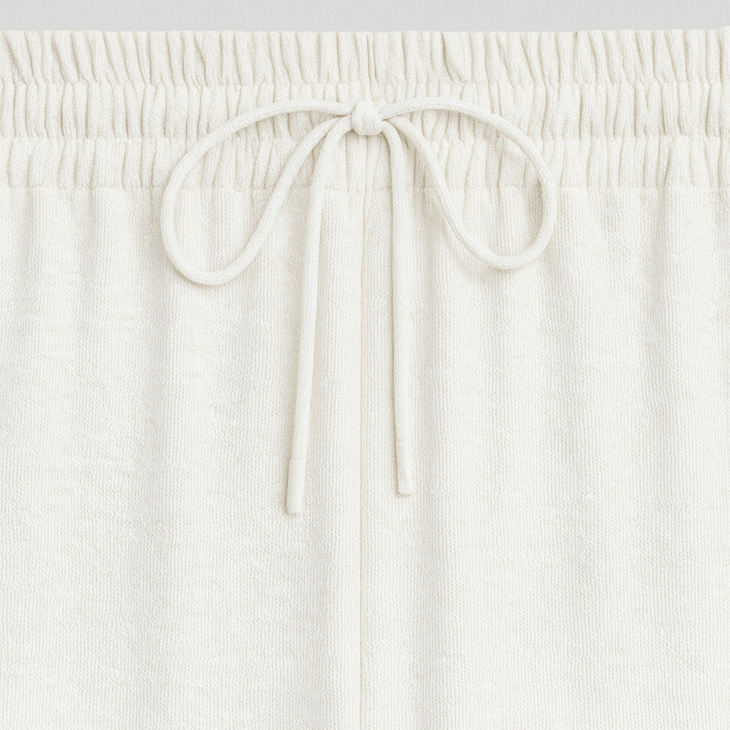 Wide-leg lounge pants with elastic drawstring waistband and flowy drape, styled for casual elegance