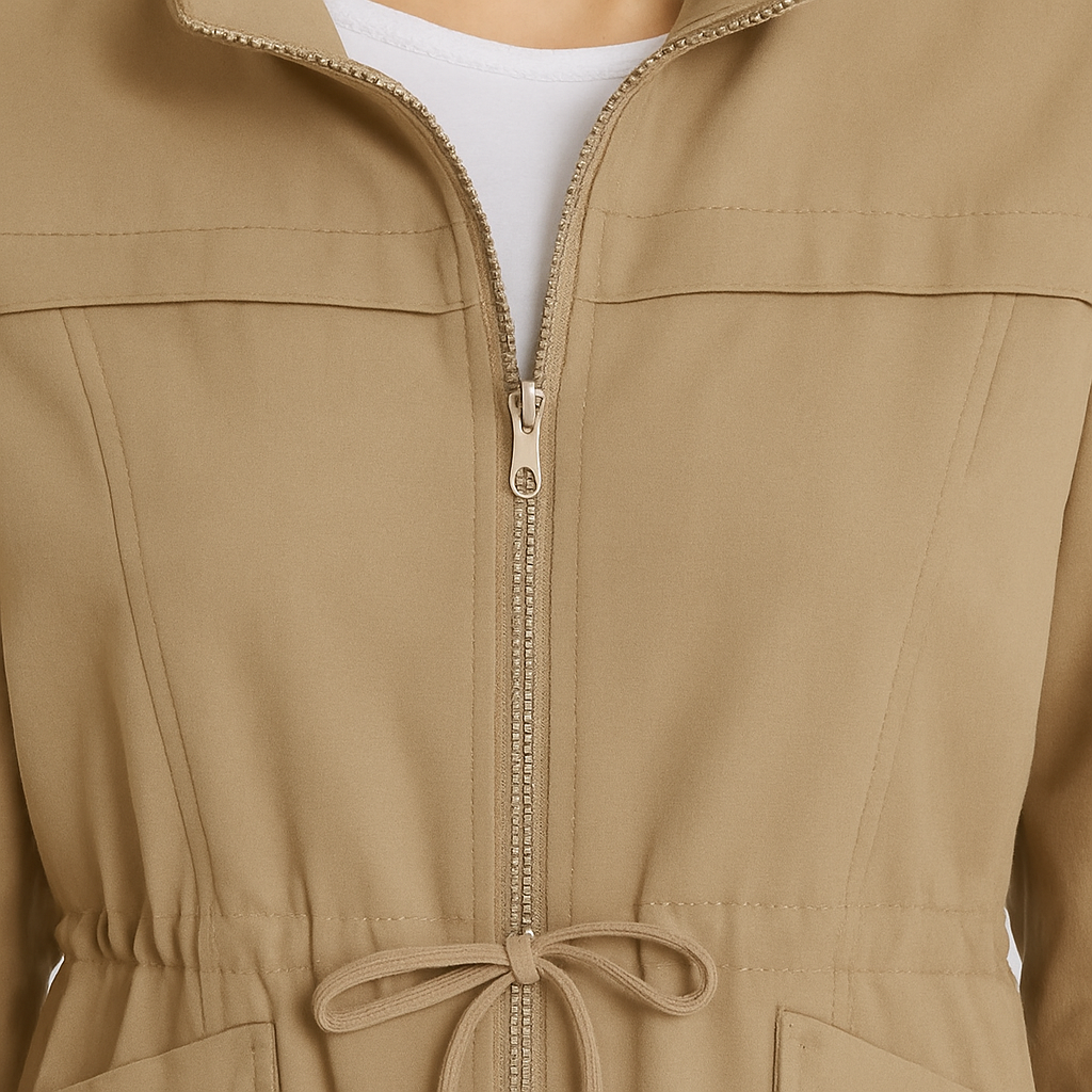 Utility jacket with front zip closure, drawstring waist, flap pockets, and elastic cuffs.