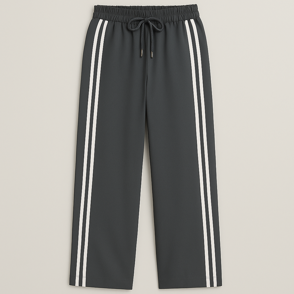 Wide-leg track pants with elastic waistband, drawstring, and double side stripes, styled for modern athletic casual looks